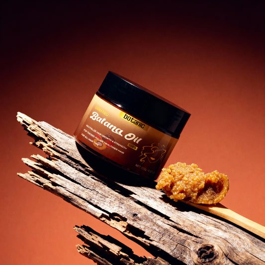 Jar of Balama Oil with a piece of oil on a wooden stick against a brown background